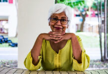 grandmother sitting at a table outside