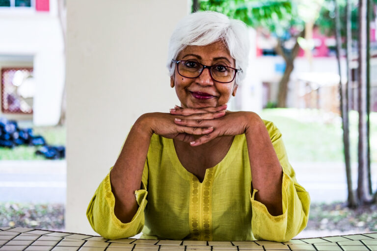 grandmother sitting at a table outside